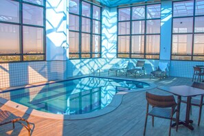 Relax by the pool surrounded by a geometric pattern and lounge chairs.