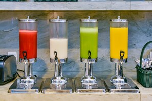 Enjoy a refreshing drink from our beverage station, featuring a selection of cold beverages.