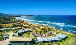 A resort with multiple buildings, a beach, and a pool area. - 2417 at Lihue Oceanfront Resort (Lihue)