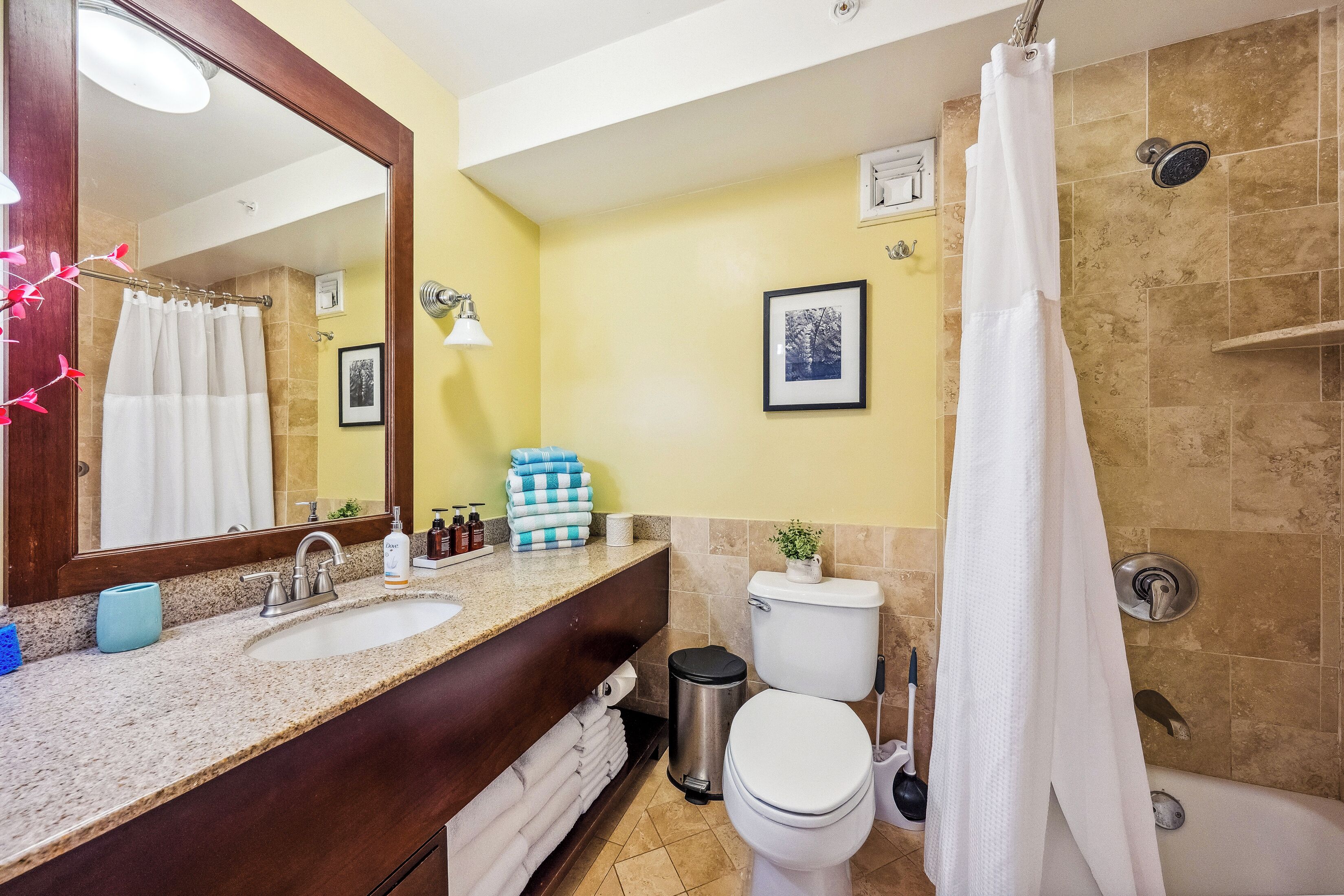A bathroom with a sink, toilet, and shower.