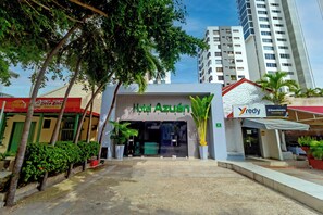 A hotel entrance with a modern facade, a visible entrance door, and a clear sky in the background. - Hotel Azuan Suites By Geh Suites (Cartagena)