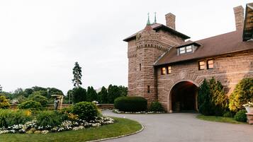 A stone building with a turret and an arched entrance.