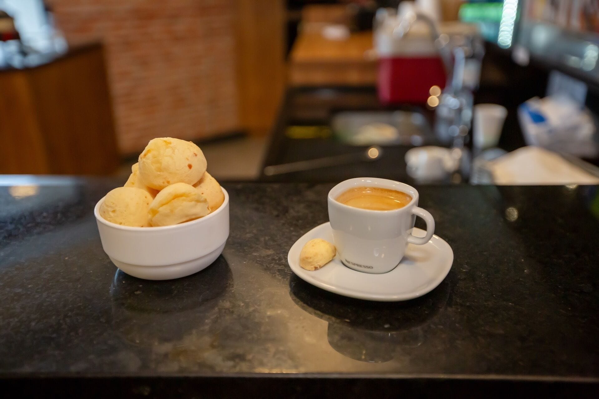 A cup of coffee and a bowl of ice cream on a table.