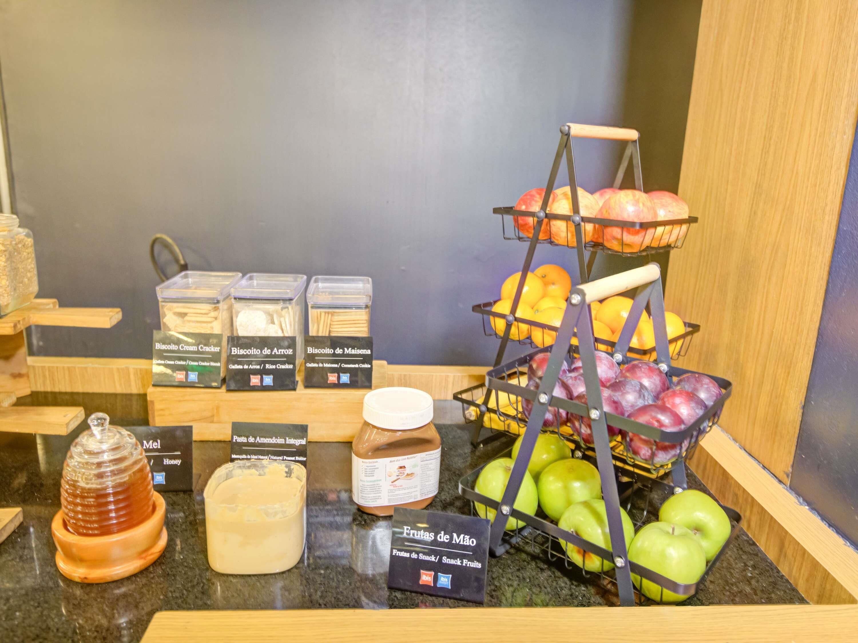 A display of food items including biscuits, honey, and apples.