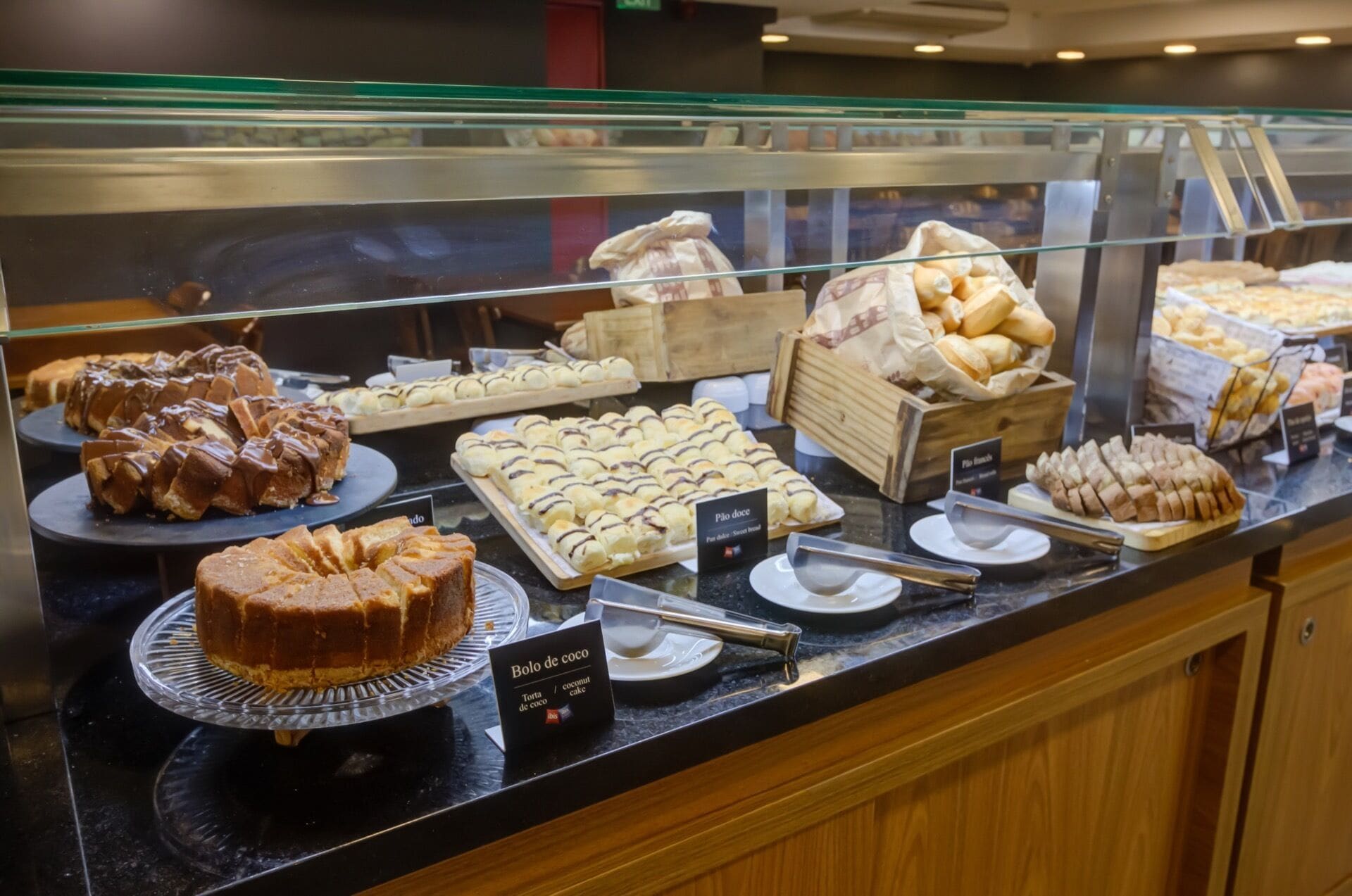 A bakery display case with various pastries and cakes.