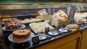 A bakery display case with various pastries and cakes.