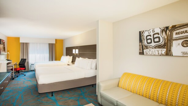 A hotel room with two beds, a sofa, a desk, and a chair. - Holiday Inn Express & Suites Litchfield West by IHG (Litchfield)