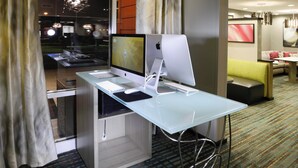 A hotel room with a glass desk, two monitors, a desktop computer, and a sofa. - Residence Inn Augusta (Augusta)