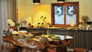 A dining area with a wooden table, various dishes, and a window with decorative paper. - Yunju Hotspring Villa (Jiaoxi)