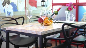 A table with two wine glasses, a bottle of champagne, a fruit basket, and a pitcher. - WELL PLUS BNB Guest House (Seoul)