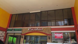 A building with a 'Cafe & Restrooms' sign, a 'Casitas' sign, and a 'Hiring Hotel Staff' sign.