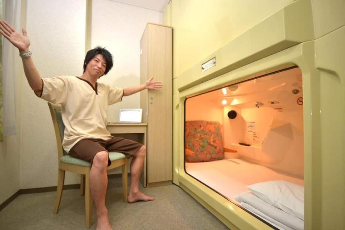 A room with a bed, a desk, and a chair.
