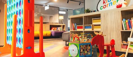 A children's play area with colorful toys and bookshelves.