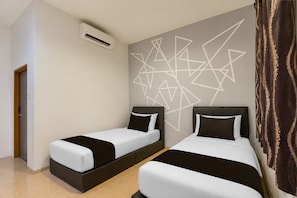 A hotel room with two beds, a geometric wall design, an air conditioning unit, and a patterned curtain.