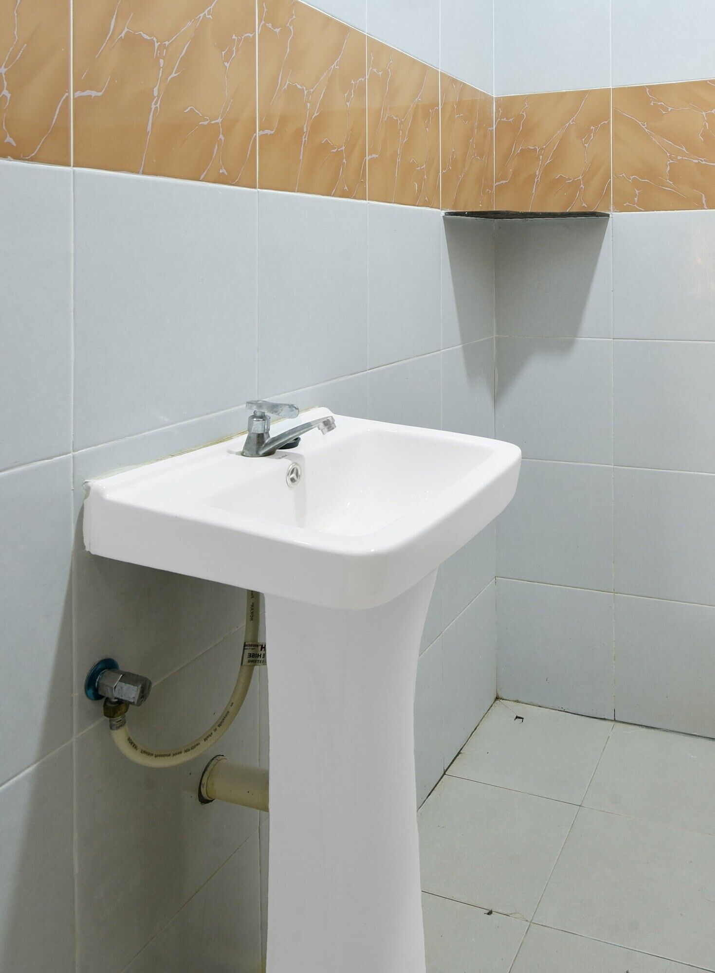 A bathroom with a white sink, a mirror, and a towel rack.