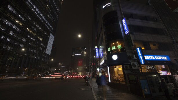 A nighttime city street with a coffee shop named 'EDIYA COFFEE' on the right. - K-Guesthouse Myeongdong 1 (Seoul)