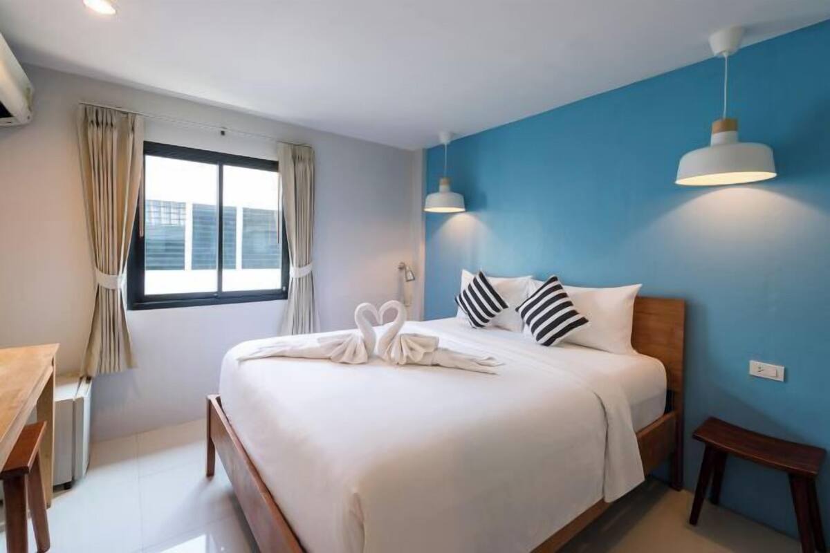 Premium bedding, desk, laptop workspace, blackout drapes