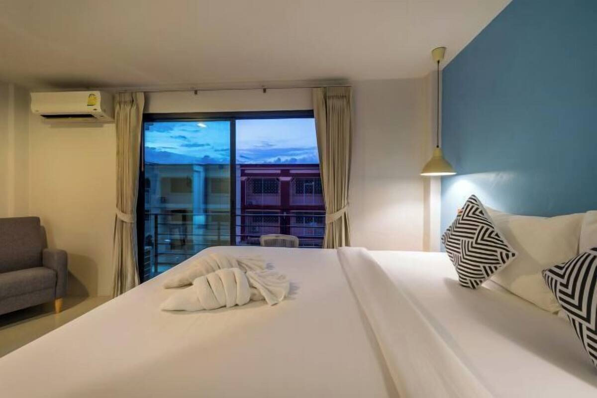 Premium bedding, desk, laptop workspace, blackout drapes