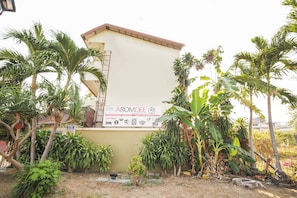 Residents of AROMDEE apartments enjoy a convenient lifestyle with a nearby Mini Mart and lush tropical surroundings.