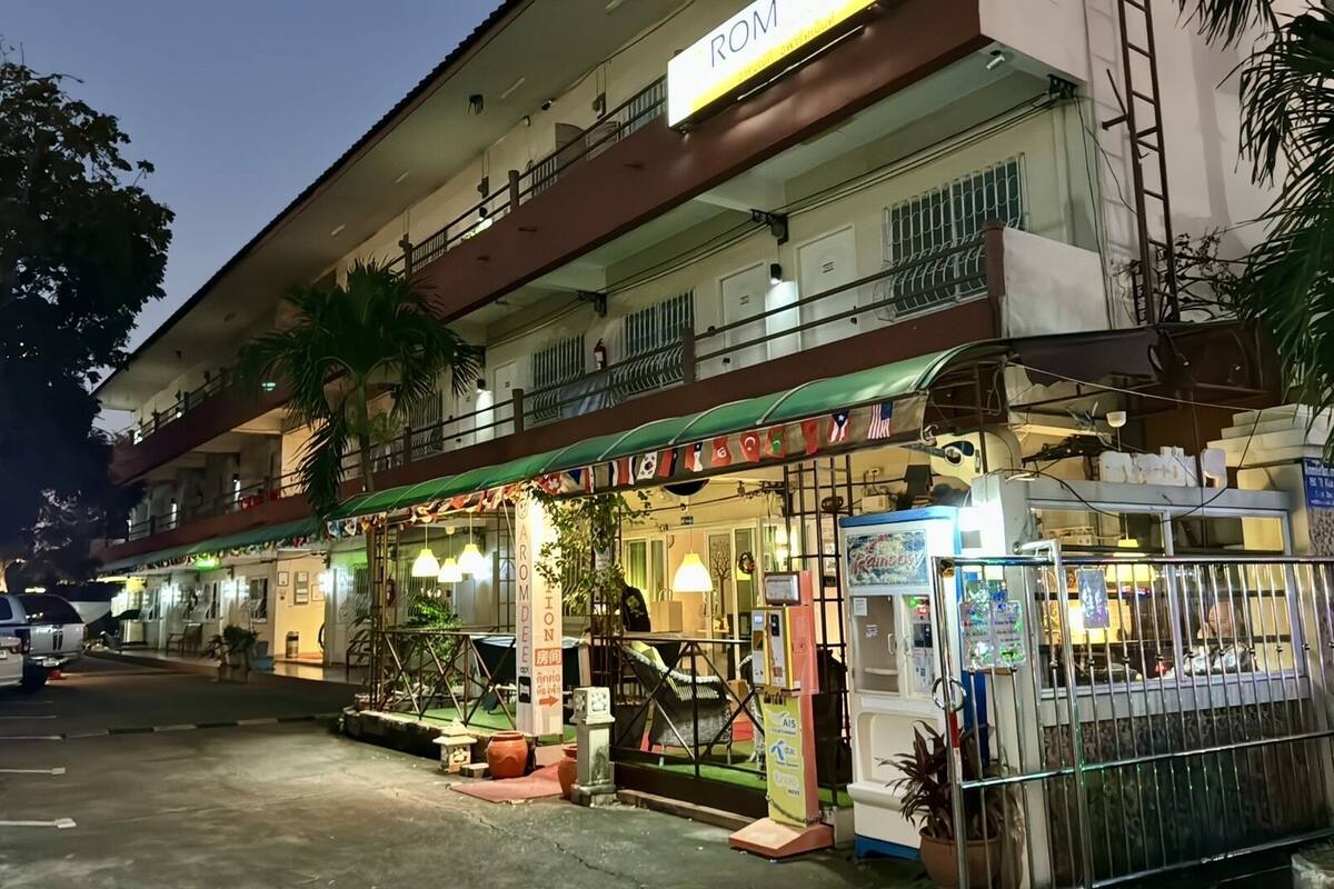 A hotel with a sign reading "ROMED".