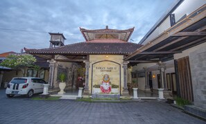 Un edificio tradicional con techo de tejas y un letrero que dice "TAMAN SARI II COTTAGE".