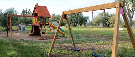 A playground with a swing set and a slide.
