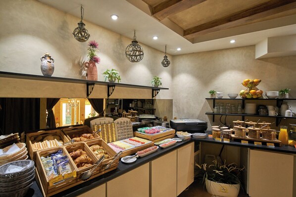 A breakfast buffet with various food items and a coffee station.