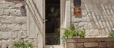 A stone building with a door labeled "Life Palace Heritage Hotel."
