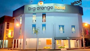 A hotel with a modern design, featuring a prominent 'big orange hotel' sign.
