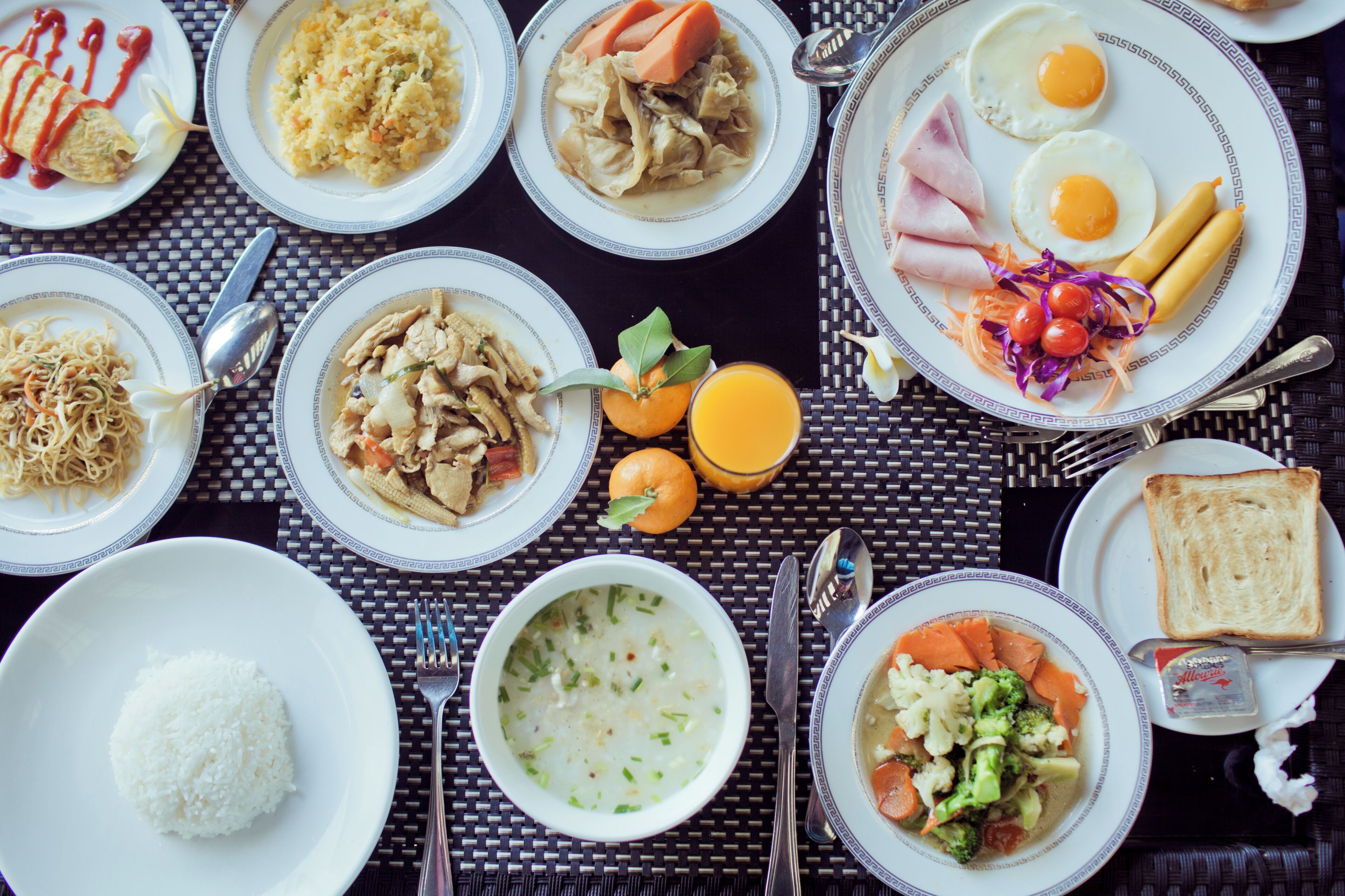 A table with various dishes including rice, soup, and vegetables.