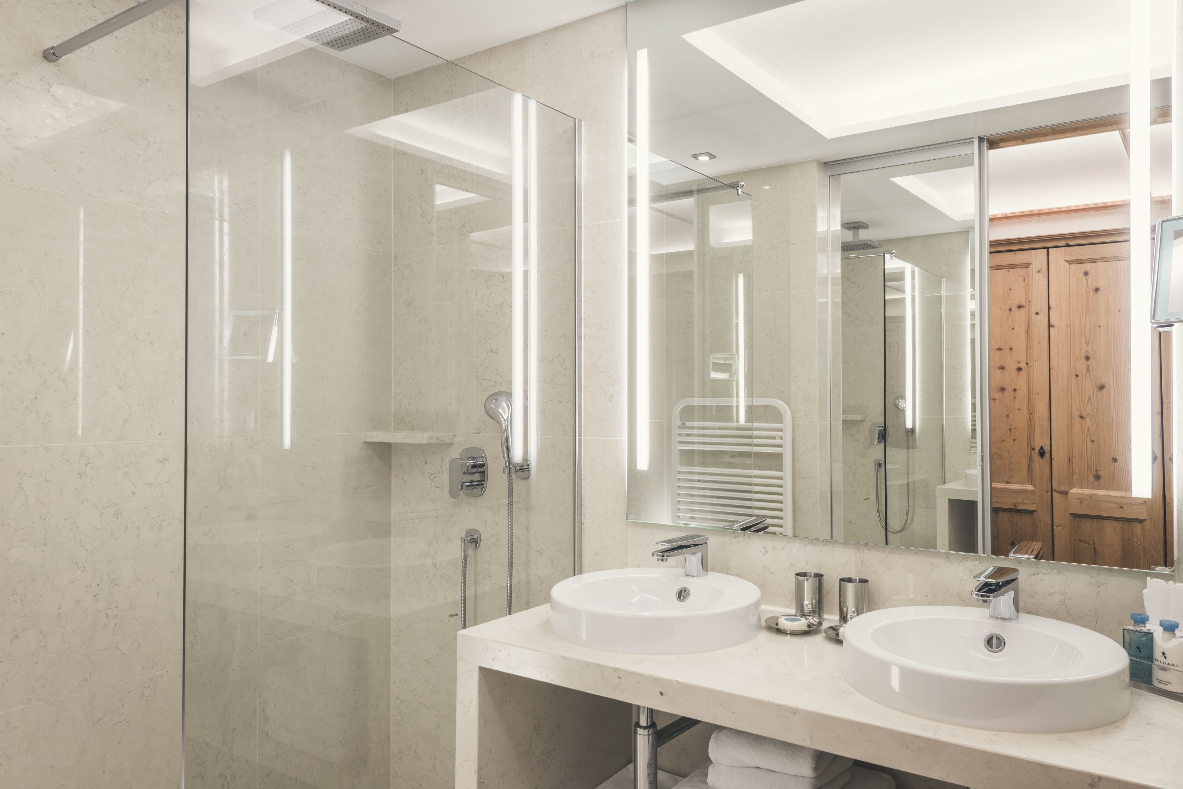 designer toiletries, hair dryer, bathrobes, slippers