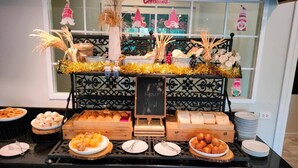A buffet setup with various food items, a chalkboard sign, and decorative elements. - Kensington English Garden Resort Khaoyai (Pak Chong)
