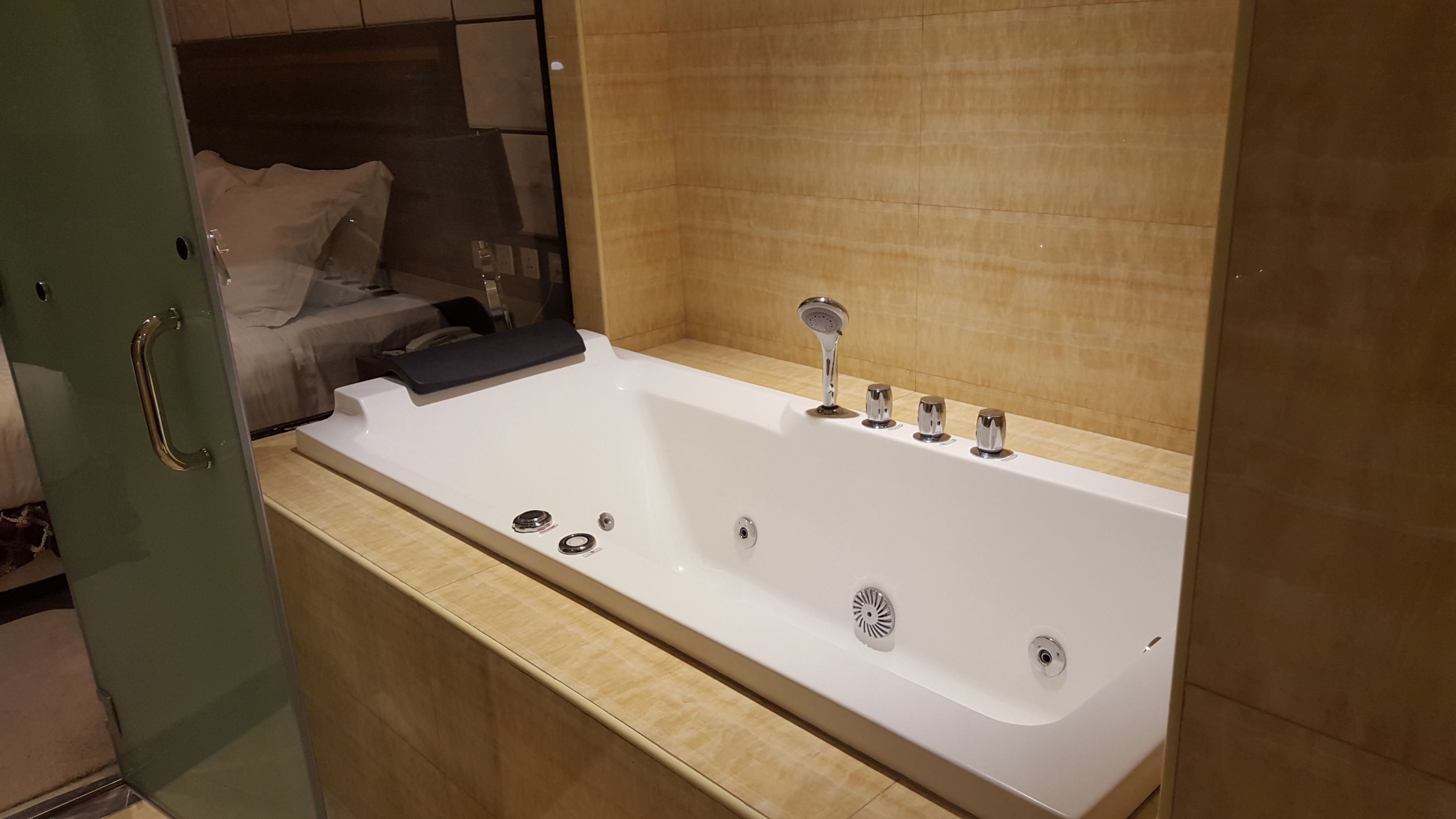 A modern bathroom with a large bathtub, a shower, and a toilet.