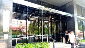 A modern building with a glass facade and a sign reading "Prime Asia Hotel". - Prime Asia Hotel (Angeles City)