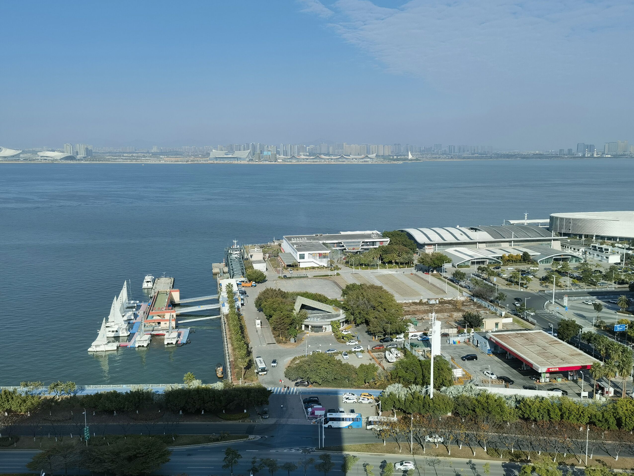 Une propriété située au bord de l’eau, dotée d’une marina, d’un grand bâtiment à toit incurvé et d’un parking.