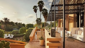 A modern outdoor area with a staircase, seating, and a covered seating area. - Mandarin Oriental, Marrakech (Marrakech)