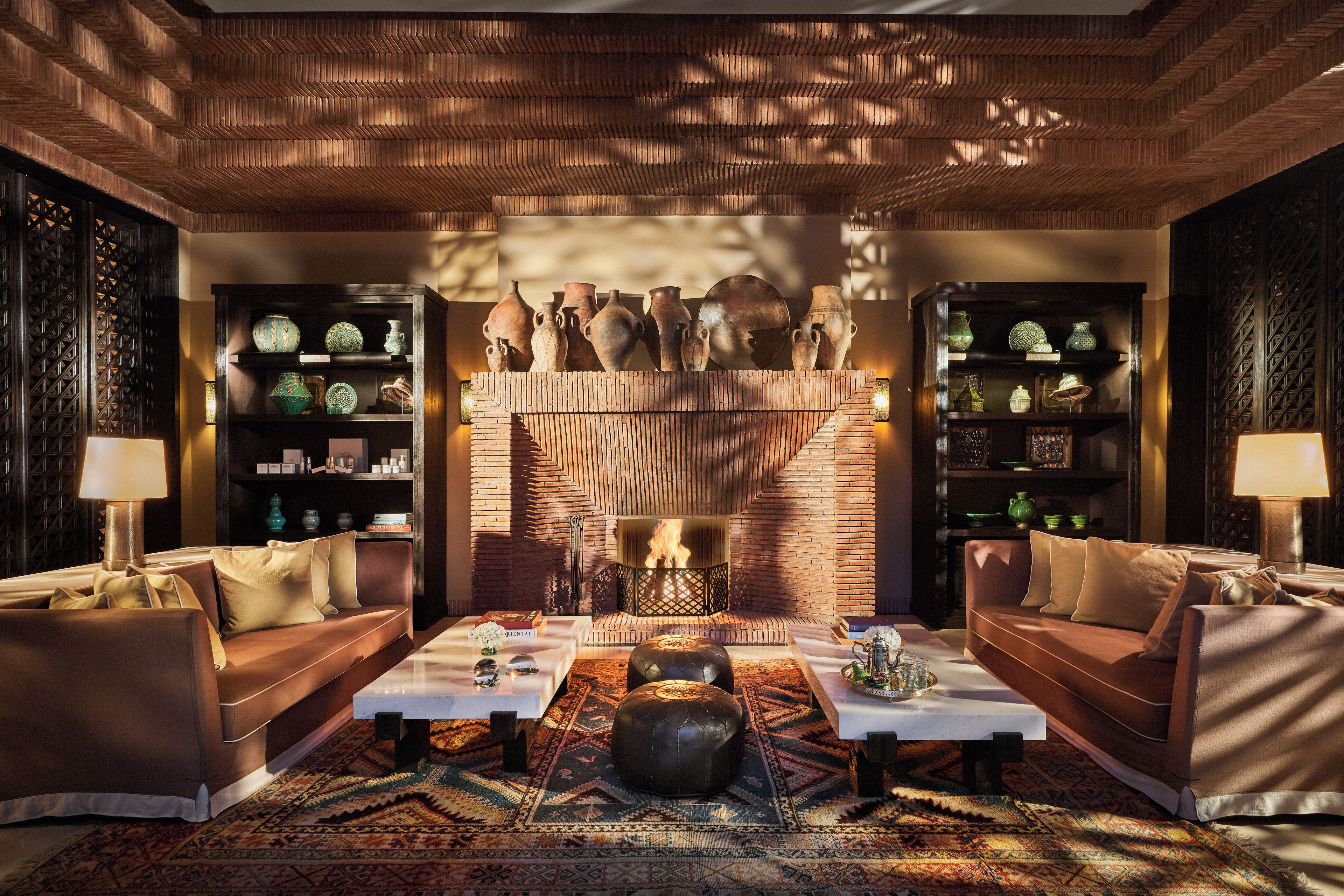 A cozy living room with leather sofas, a coffee table, and a fireplace.