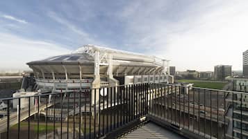A stadium with a modern design, featuring a large roof and multiple levels.
