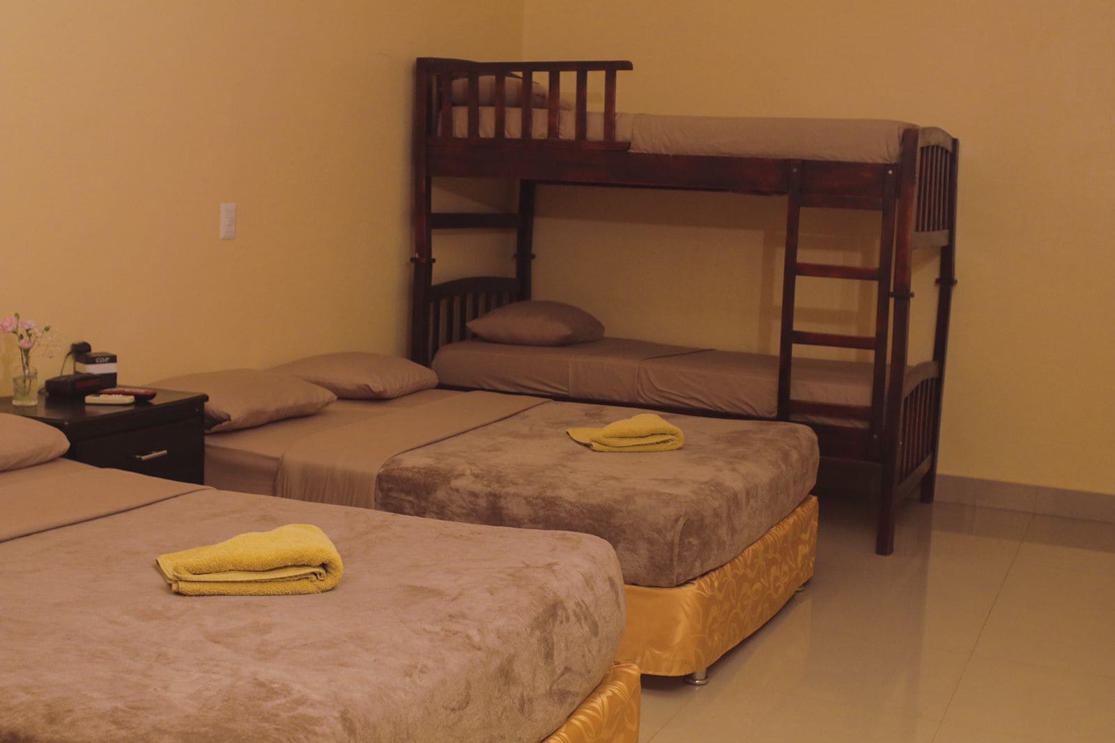 A bunk bed room with two single beds and a nightstand.