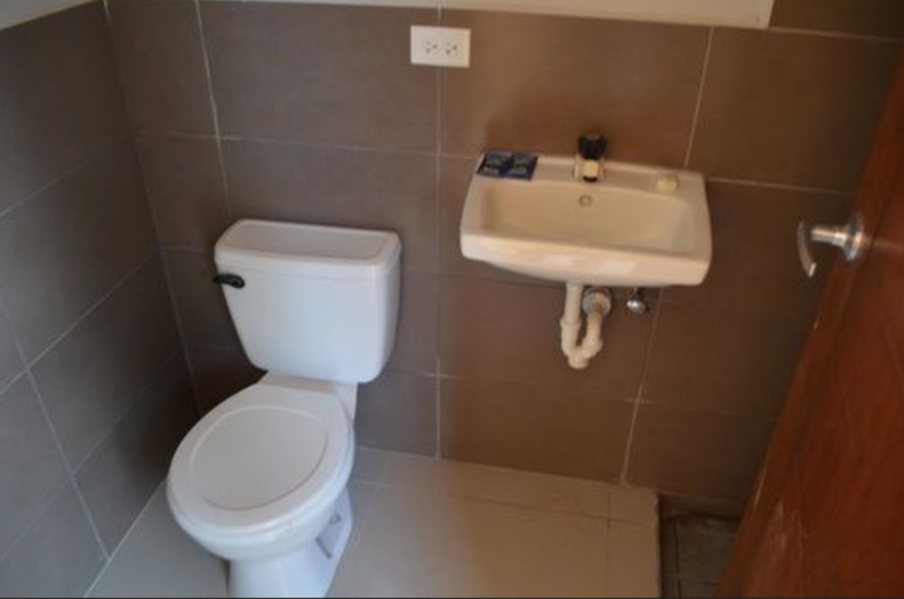 A bathroom with a toilet and a sink.