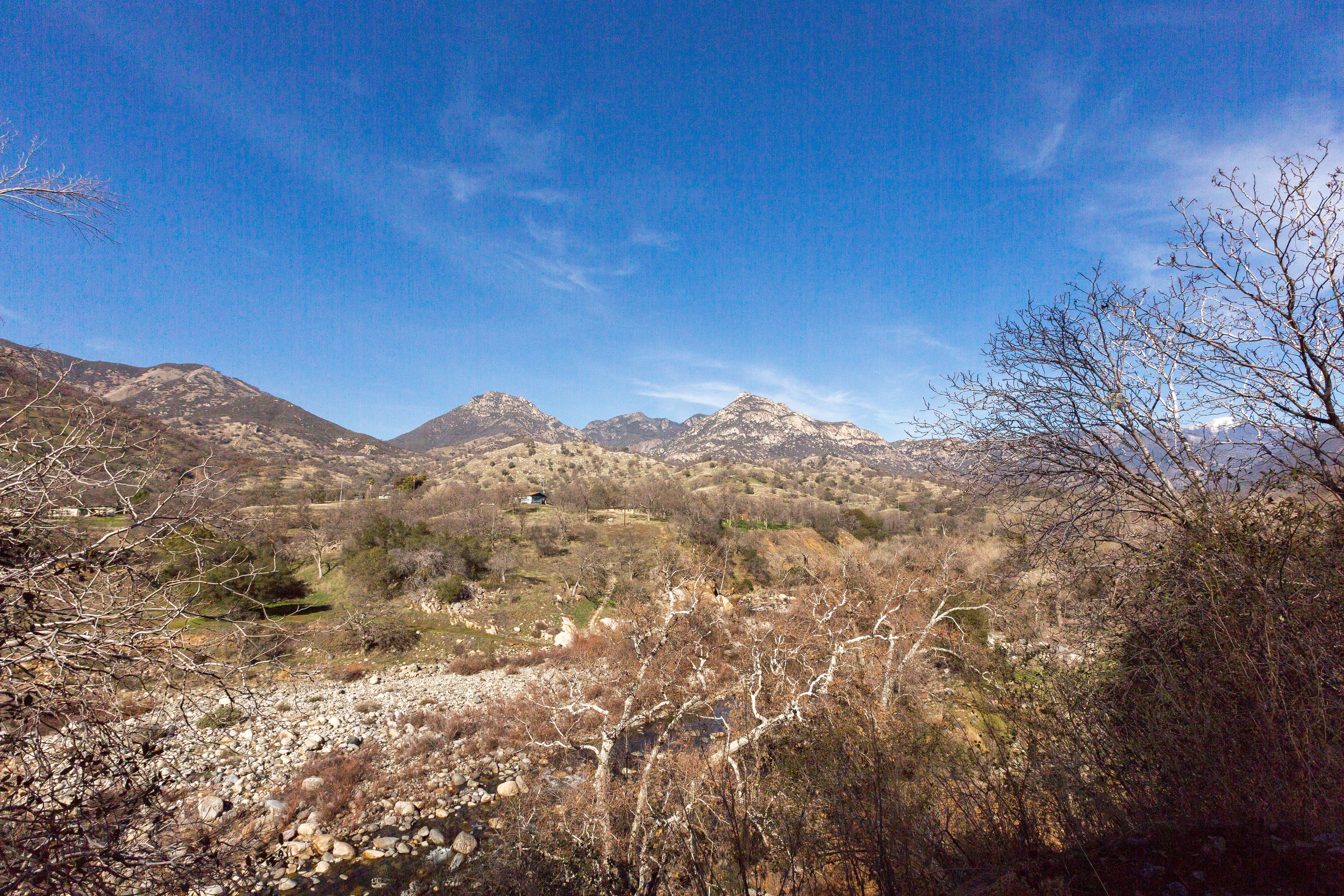 A mountainous landscape with rocky terrain and sparse vegetation.