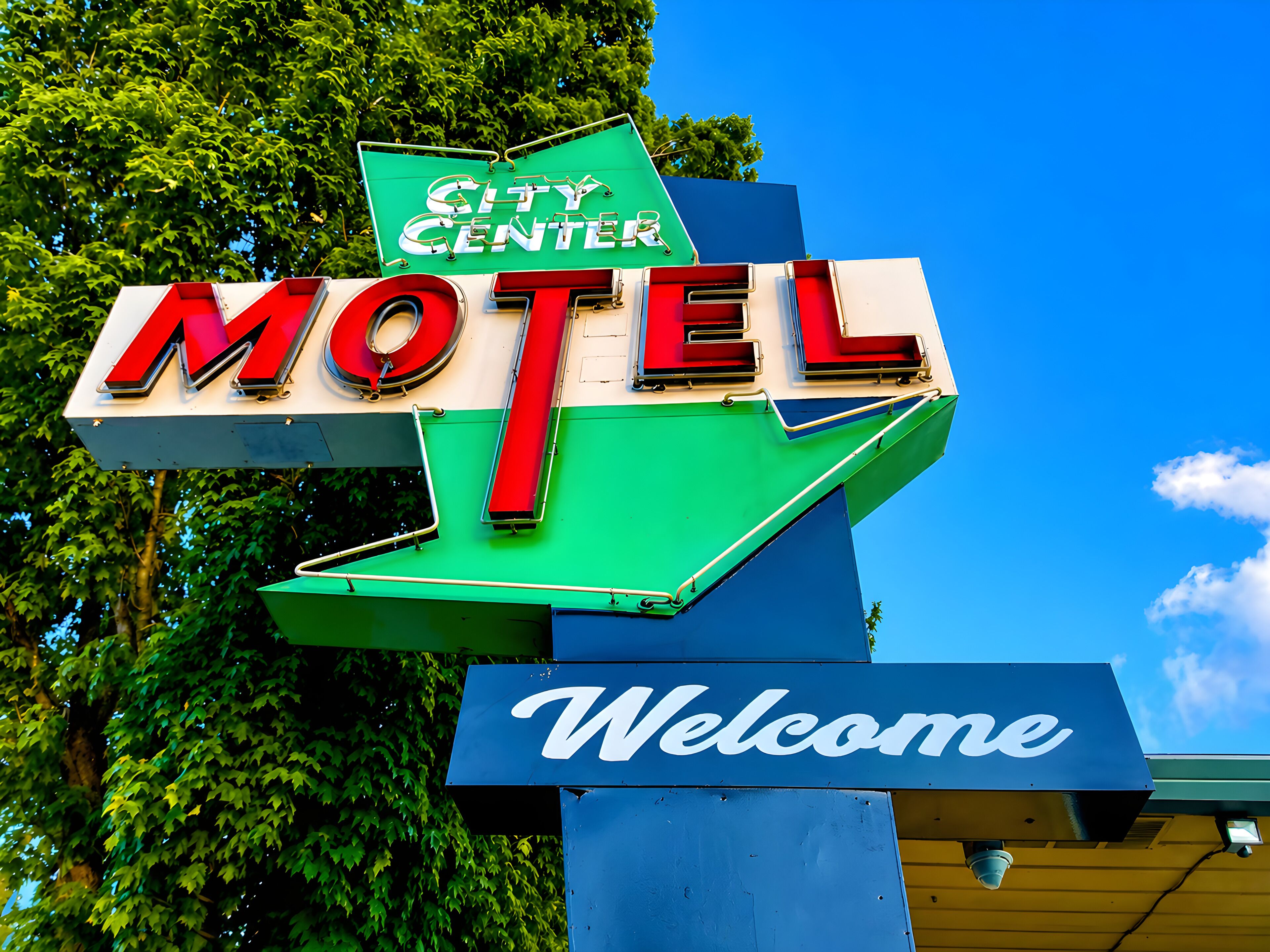 A motel sign with 'City Center' and 'Welcome' text.