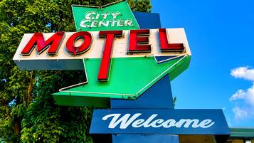 A motel sign with 'City Center' and 'Welcome' text.