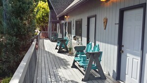 A wooden deck with outdoor seating and a covered area. - Sweetgrass Inn B&B (Rapid City)