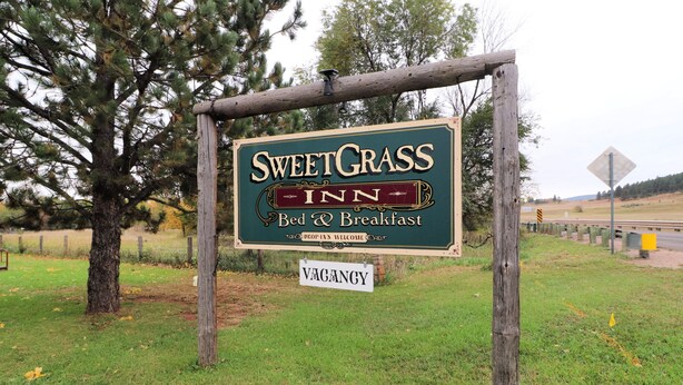 A sign for SweetGrass Inn, indicating it offers bed and breakfast services. - Sweetgrass Inn B&B (Rapid City)