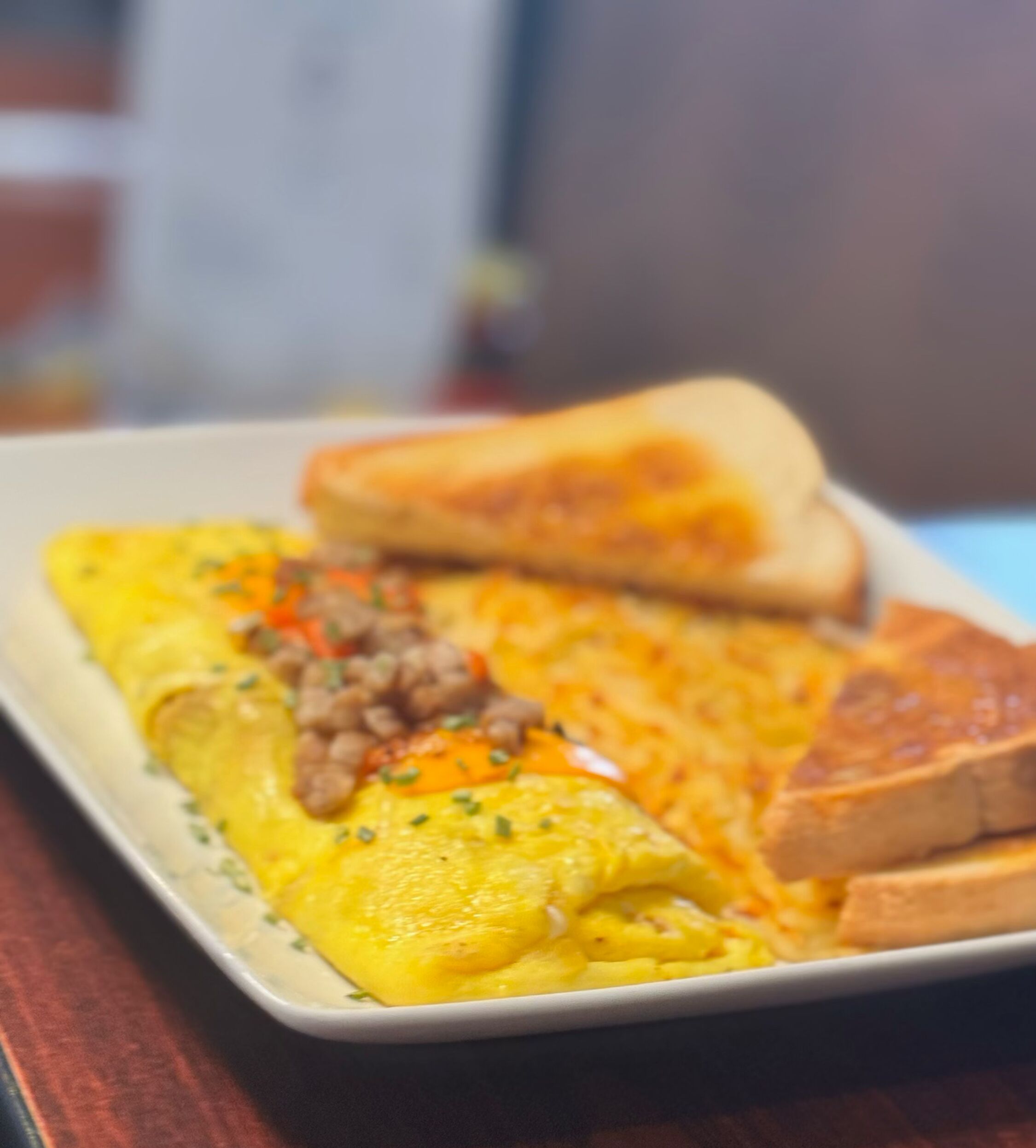 A plate with an omelette and two pieces of toast.