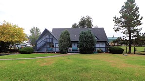 A two-story house with a steeply pitched roof, a front porch, and a well-maintained lawn. - Sweetgrass Inn B&B (Rapid City)