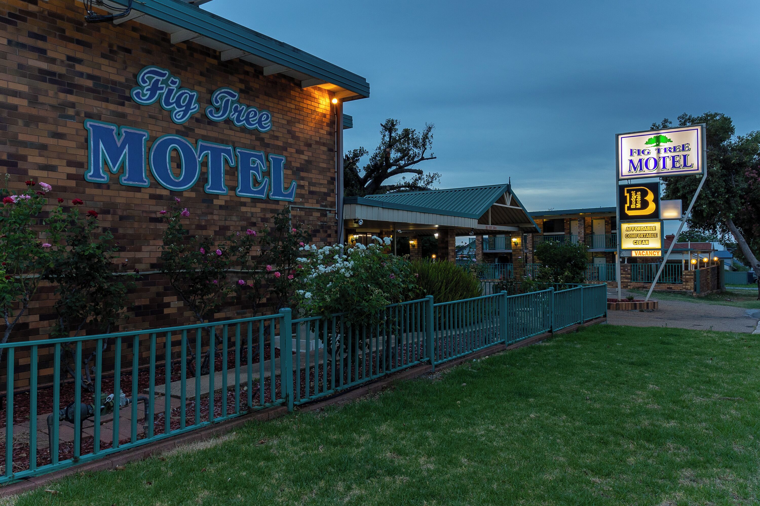 A brick building with a sign reading "Fig Tree Motel."
