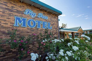 The exterior of the Fig Tree Motel with a brick facade and a signboard.
