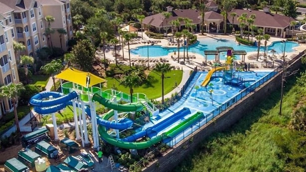 A water park with multiple slides and pools, surrounded by residential buildings. - Windsor Hill Resort (Kissimmee)